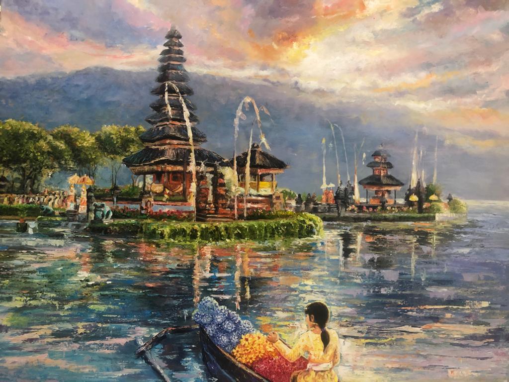 A woman in a flower boat on the lake at Ulun Danu Temple in Bali