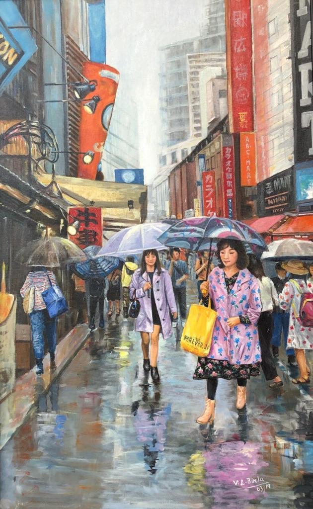 Pedestrians carrying umbrellas along a rain-soaked Tokyo street