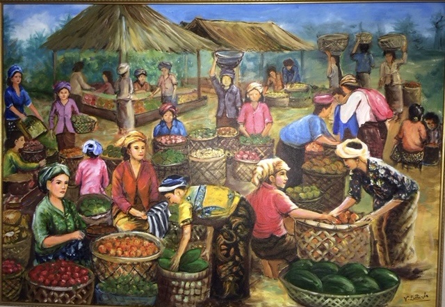 Busy open-air market with vendors sorting baskets of produce